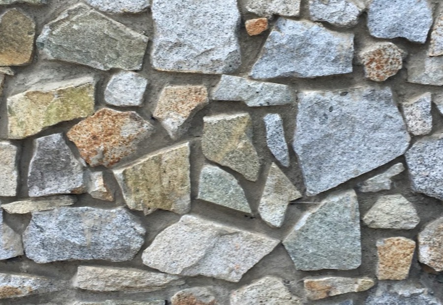 Limestone foundation joints being repointed on an older building